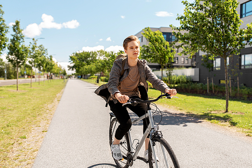 lifestyle, transport and people concept - young man or teenage student boy with backpack riding bicycle on city street