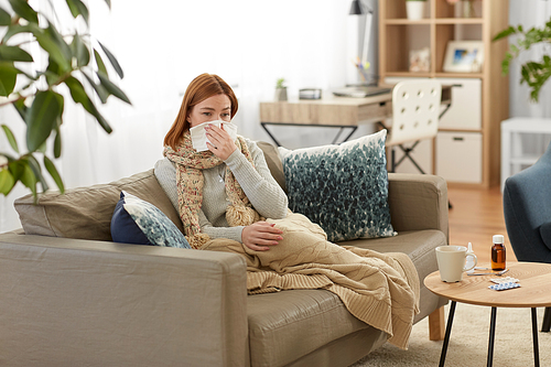 healthcare, cold, allergy and people concept - sick woman blowing her runny nose in paper tissue at home