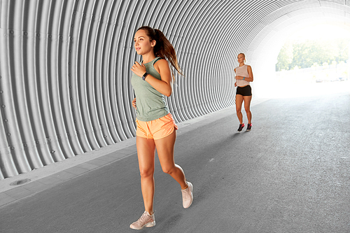 fitness, sport and healthy lifestyle concept - young women or female friends running outdoors