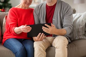 christmas, holidays and people concept - close up of happy smiling senior couple with tablet pc computer at home
