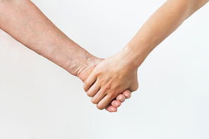 people, age and body parts concept - close up of senior and young woman holding hands