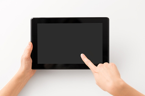 gadget and technology concept - close up of hands with black tablet computer smartphone
