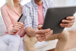family, technology, online shopping and people concept - close up of couple with tablet pc computer and credit card at home