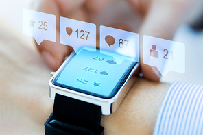 modern technology and people concept - close up of woman hands wearing smart watch with social media icons