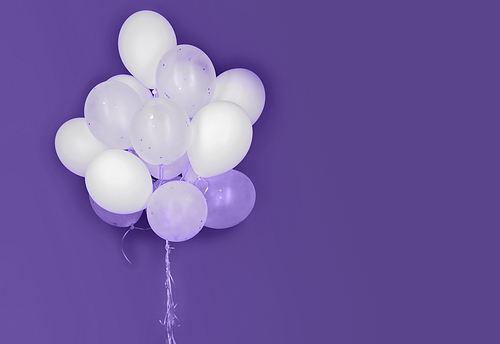 holidays, birthday, party and decoration concept - close up of inflated white helium balloons on ultra violet background