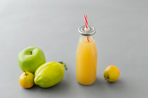 healthy eating, dieting and  friendly concept - reusable glass bottle of fruit juice with straw