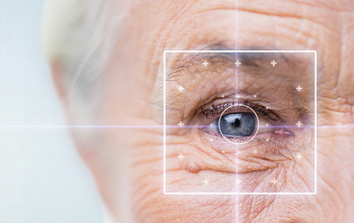 age, vision, surgery, eyesight and people concept - close up of senior woman face and eye with laser light