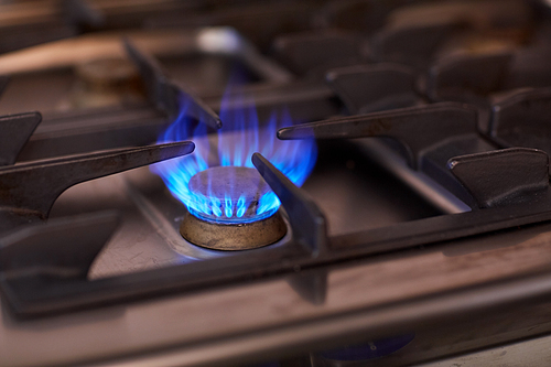 kitchen and cooking concept - burning gas stove flame