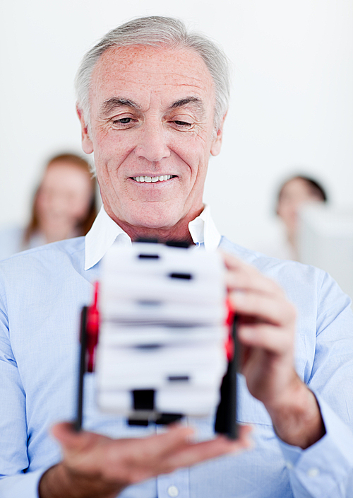 Senior businessman holding a business card holder