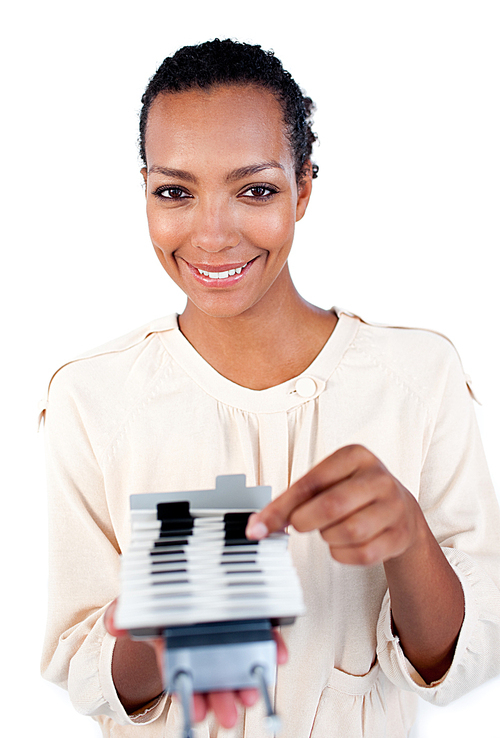 Selfassured businesswoman consulting a business card holder 