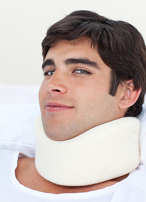 유토이미지 Close up of an attractive male patient with a neck brace