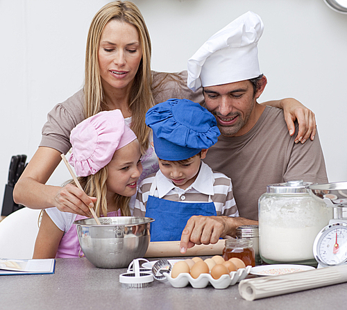 Children baking cookies with their parents