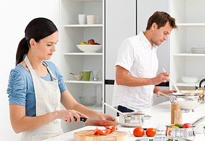 Couple preparing bolognese sauce and pasta together