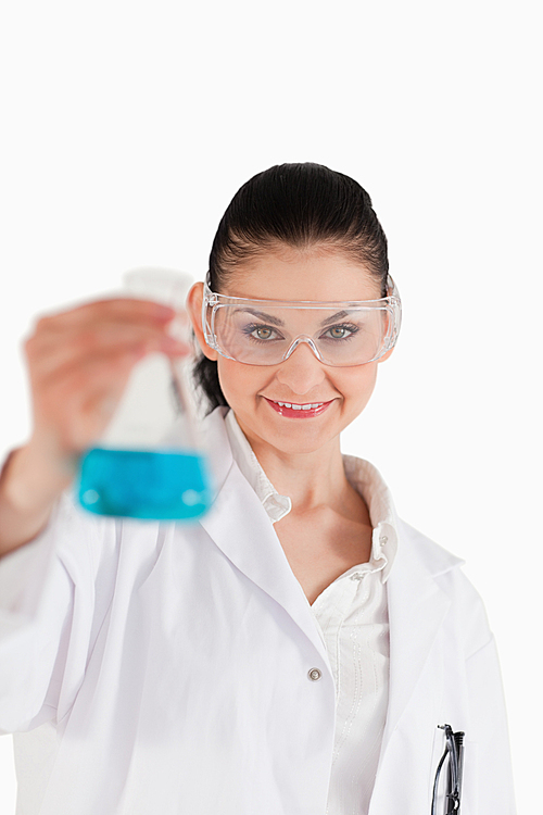 Darkhaired scientist with safety glasses holding a blue flask | 유토이미지 ...
