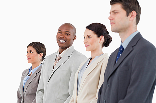 Smiling salesman standing between his colleagues