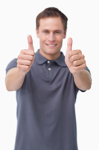 Thumbs up given by smiling young man