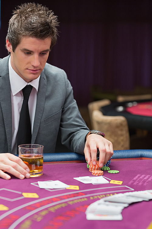 Man looking down at poker table