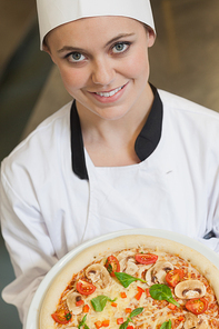 Female cook holding a pizza