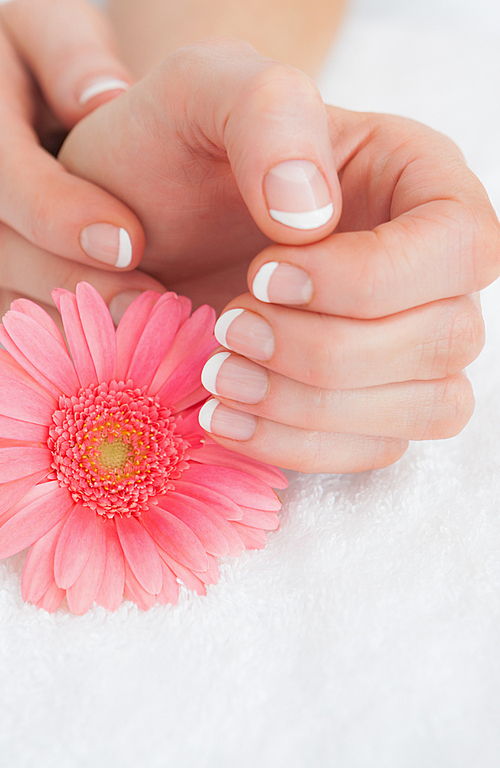 유토이미지 | Flower with french manicured fingers