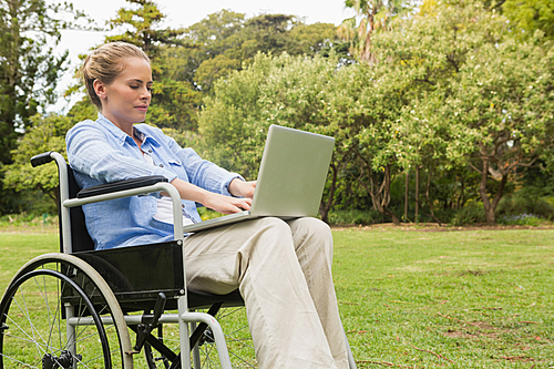 Young woman in a wheelchair with a laptop