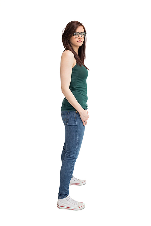 Unsmiling young woman with glasses posing