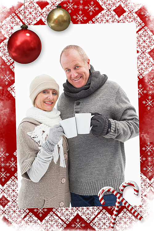 Composite image of happy mature couple in winter clothes holding mugs