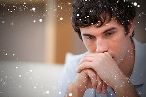 Composite image of thoughtful man in the living room