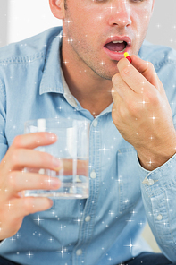 Composite image of close up of casual man taking a pill