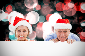 Composite image of festive couple showing poster