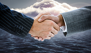 Composite image of business people shaking hands