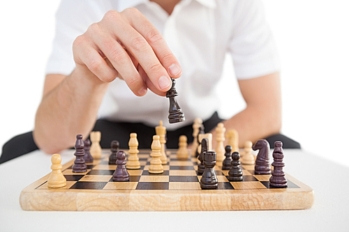 Focused businessman playing chess solo