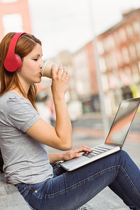 Girl using laptop|listening music and drinking coffee
