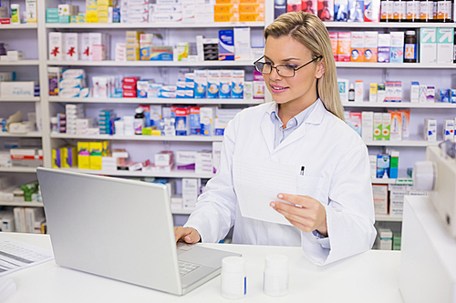 Pharmacist using the computer at the hospital pharmacy