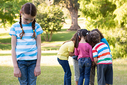 Little girl feeling left out in park on a sunny day