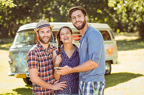 Hipster friends smiling at camera on a summers day