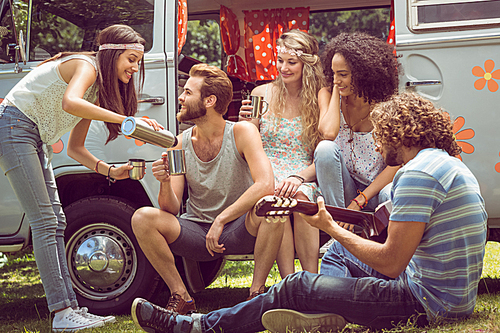 Hipster friends in camper van at festival on a summers day