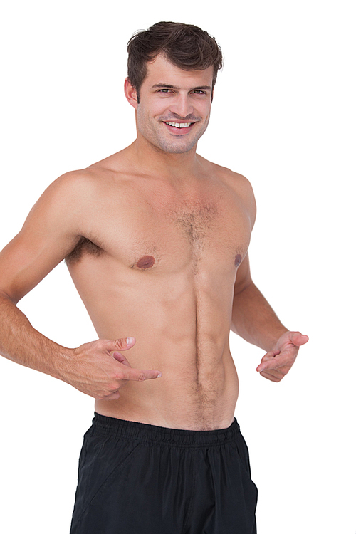 Fit shirtless man smiling at camera on white background