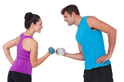 Fit man and woman lifting dumbbells on white background