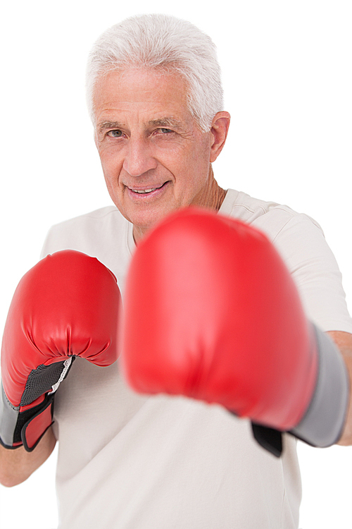 Senior man in boxing gloves on white background