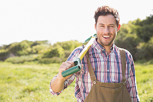 Happy farmer smiling at camera on a sunny day