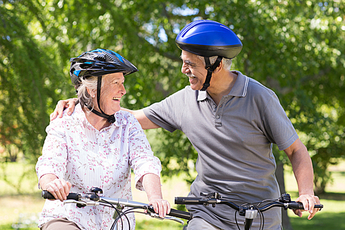 Happy senior couple on their bike on a sunny day