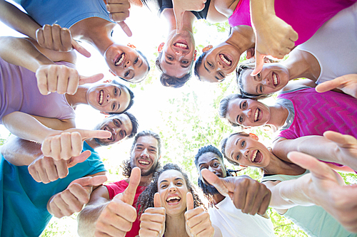 Fitness group smiling at camera in park on a sunny day