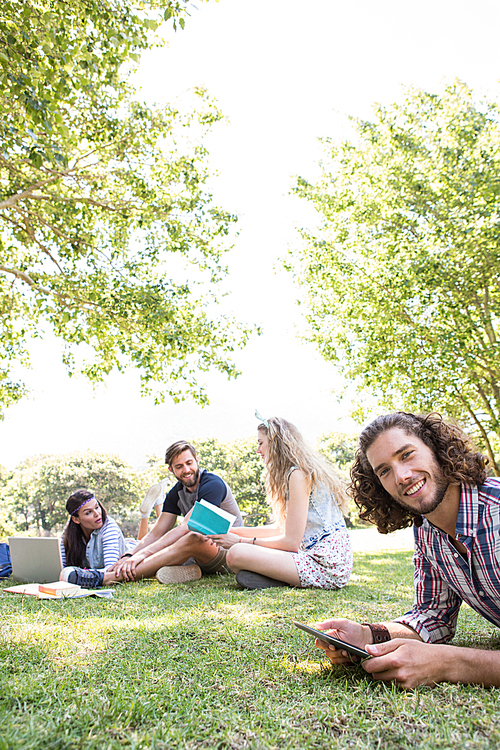 Classmates revising together on campus on a summers day