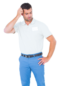 Confused male technician scratching head on white background