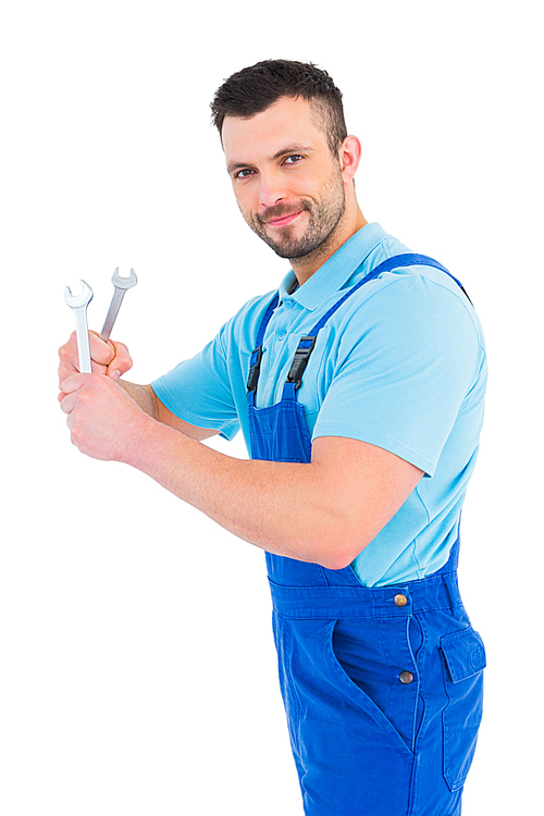 Repairman holding spanners on white background