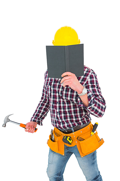 handyman reading  and holding hammer on white background