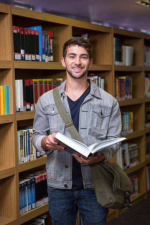 Student smiling at camera in library at the university