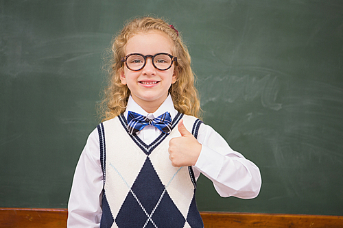 Happy pupil  with thumbs up at elementary school