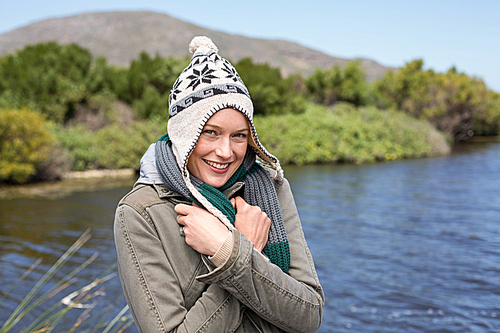 Happy casual woman at a lake in the countryside