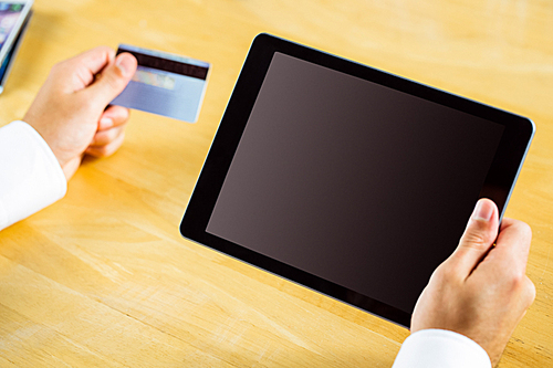 Man using tablet pc for online shopping in close up